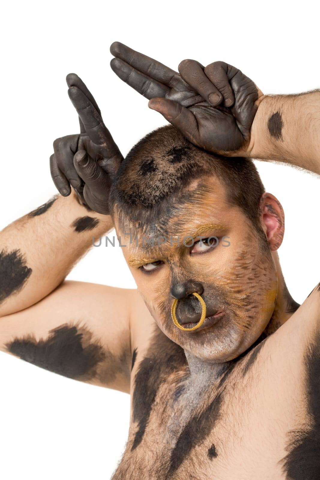 Serious man with body art showing horns and looking at camera