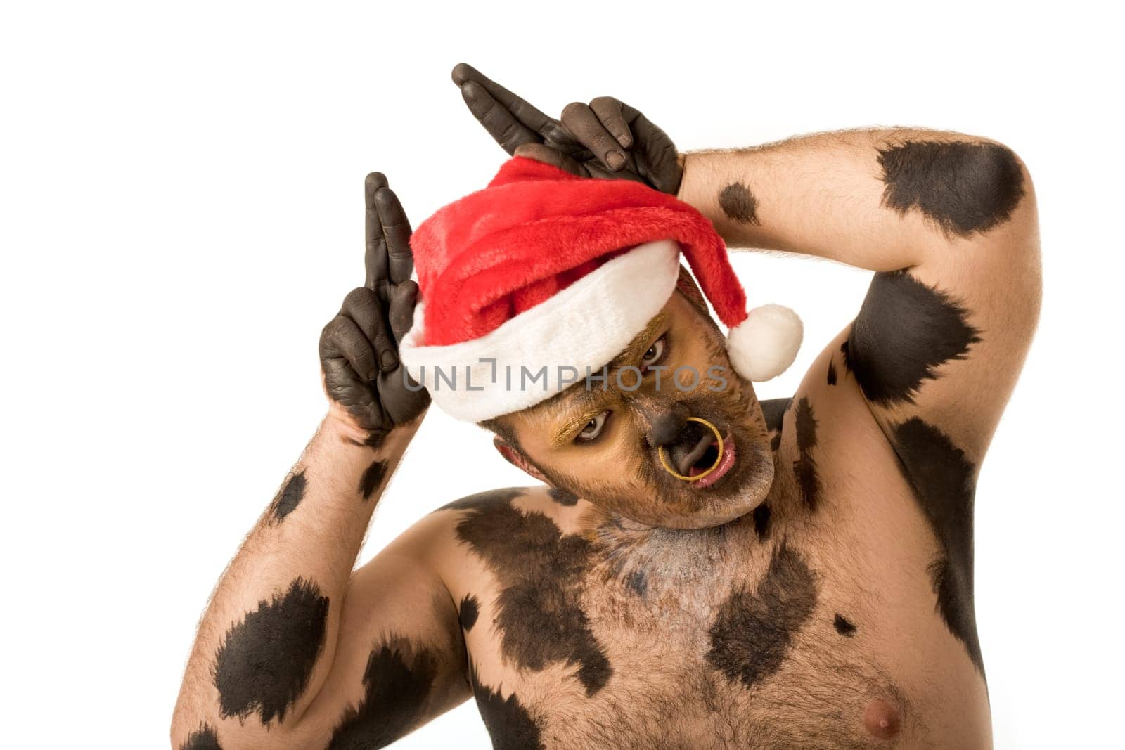 Photo of funny man with Santa cap on head showing horns and saying moo