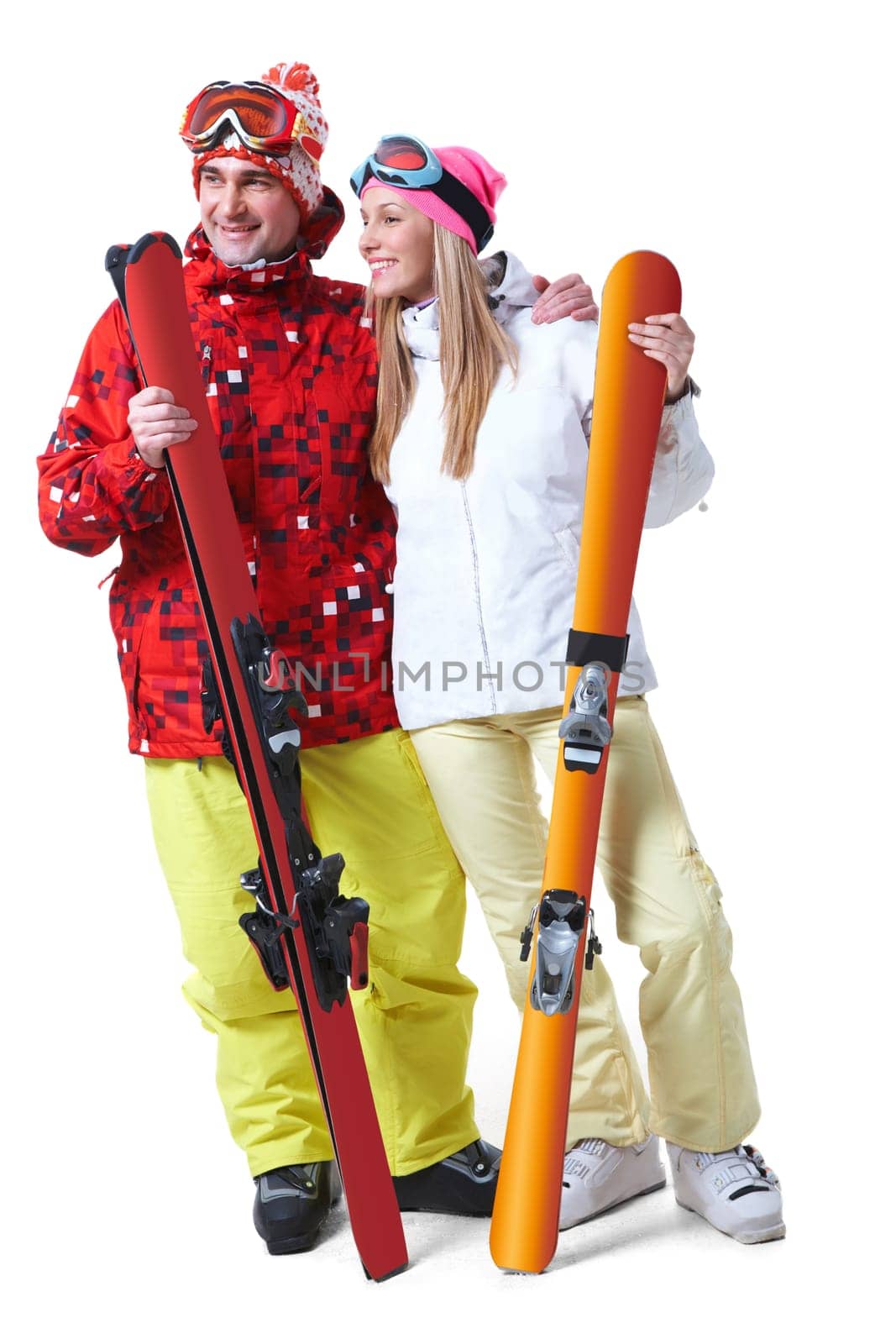Portrait of happy couple with skis in hands looking aside with smiles