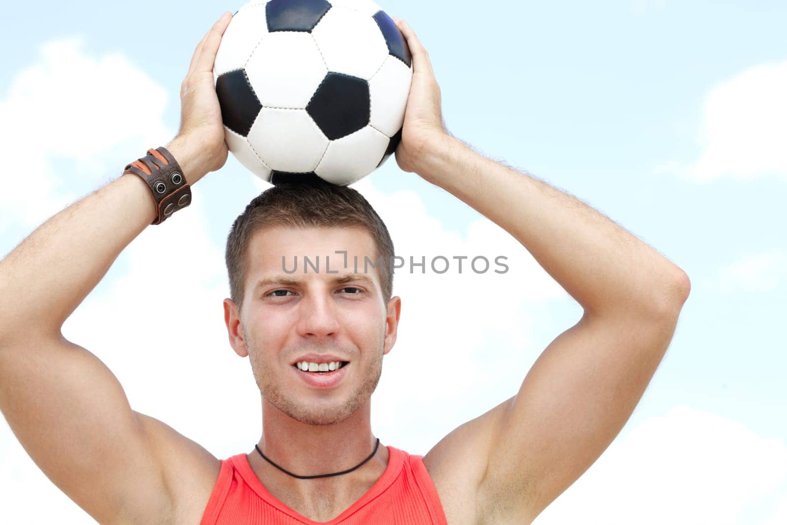 Portrait of a muscular man with football ball