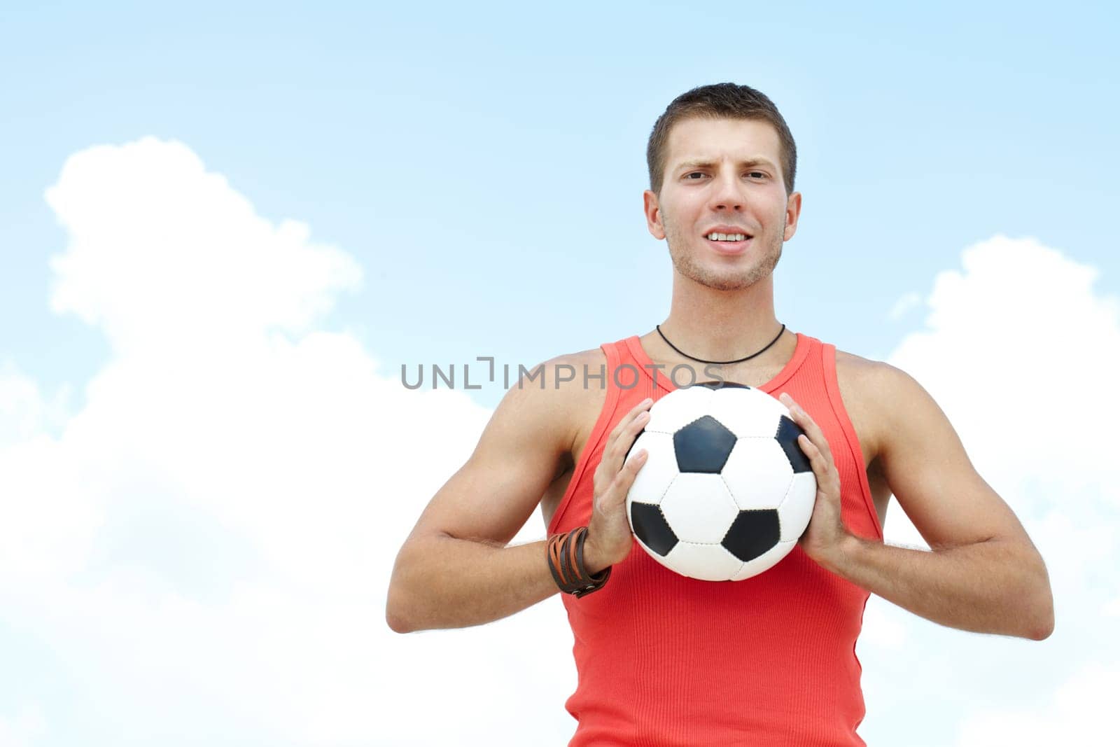 Portrait of a young man holding football ball