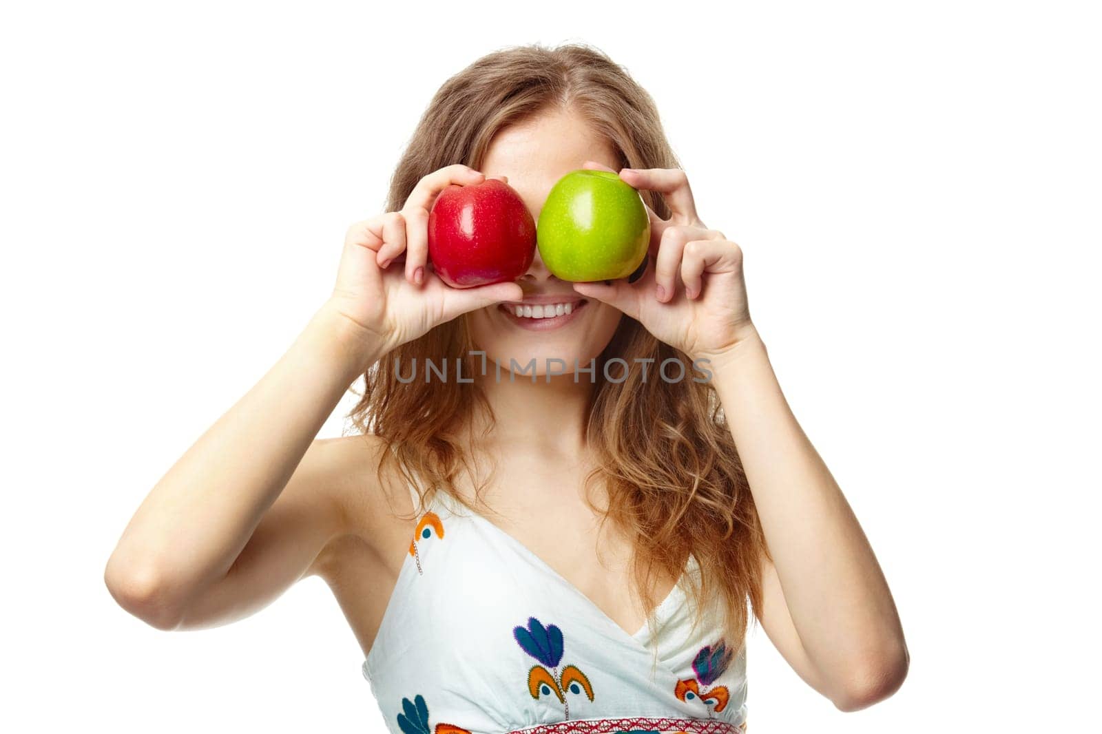 Portrait of a girl covering her eyes with apples