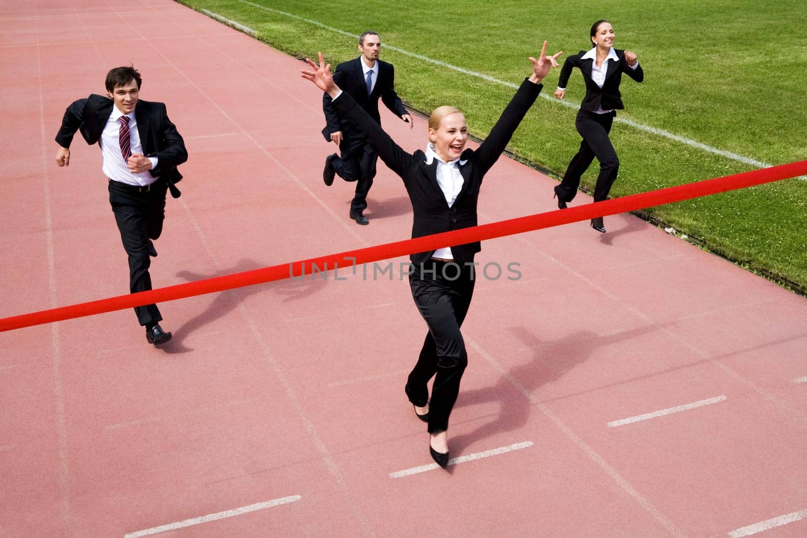 Image of joyful businesswoman winning a business race
