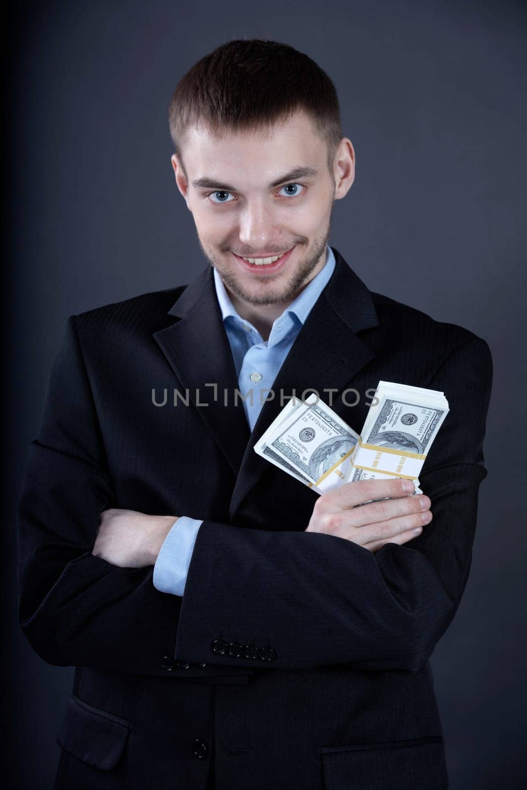 Portrait of confident businessman with dollars