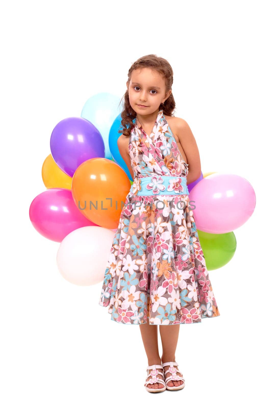 Portrait of happy girl with colorful balloons looking at camera