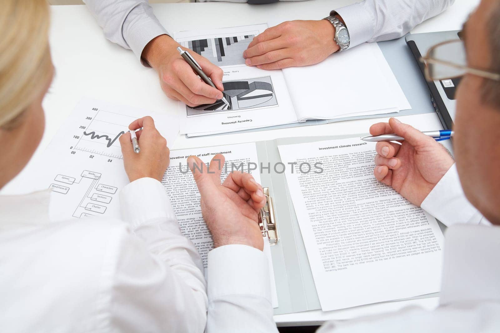 Image of workteam working with documents at business meeting