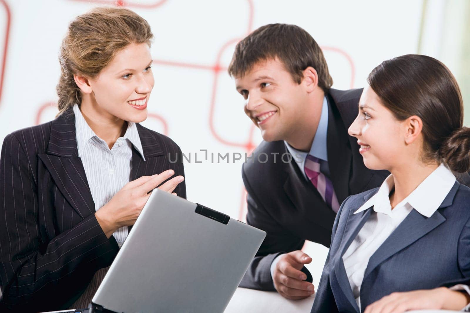 Group of three business people discussing a new plan