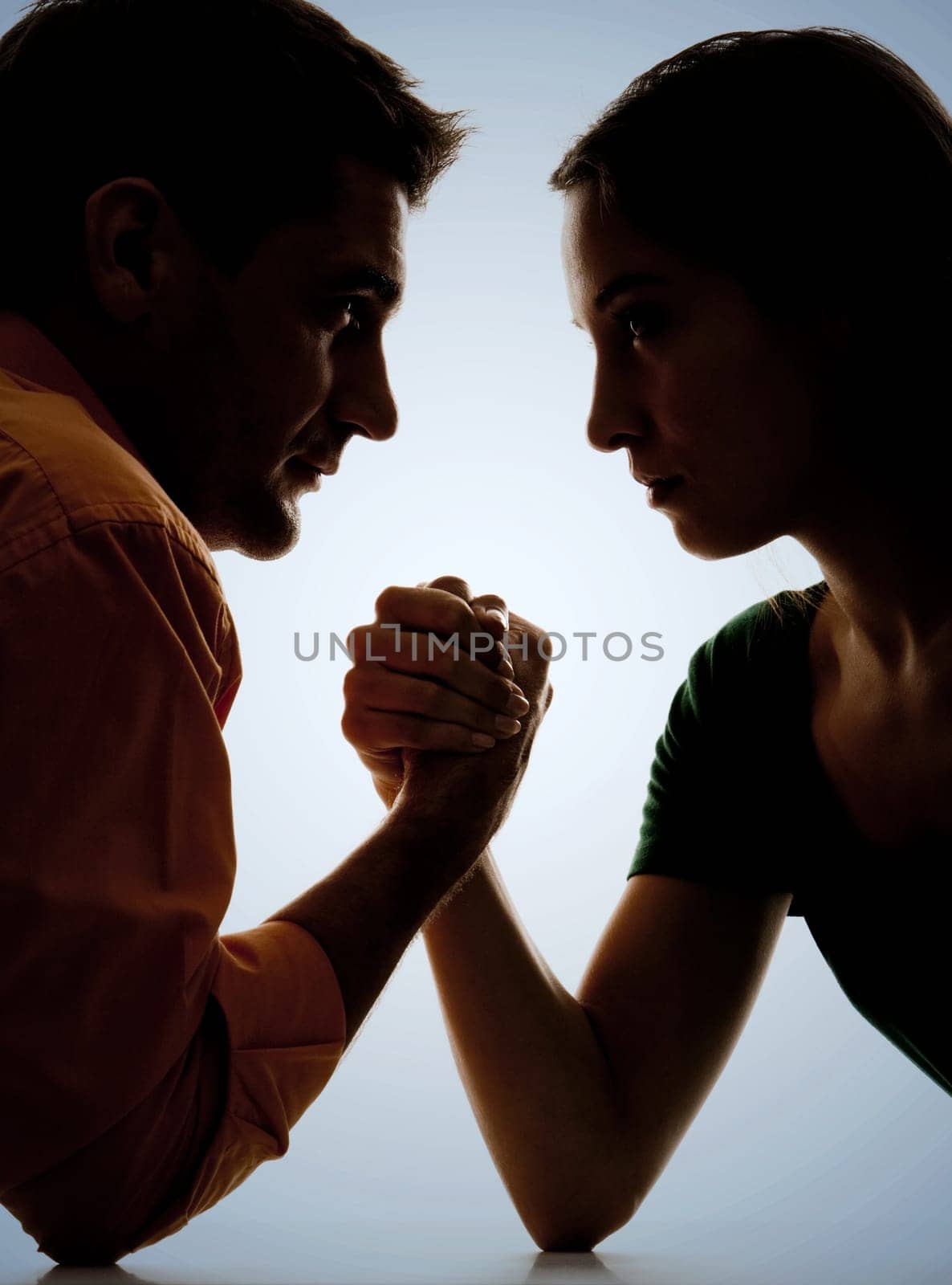 Close-up of dark figures of man and woman having struggle