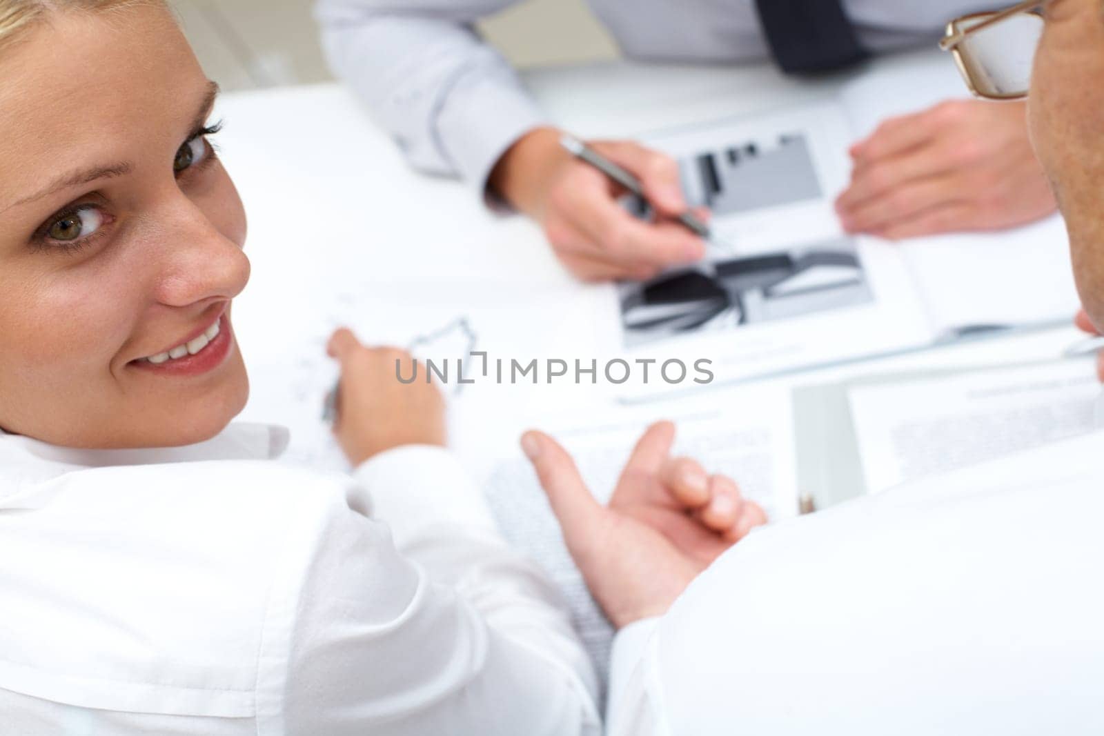 Image of pretty employee looking aside during conversation