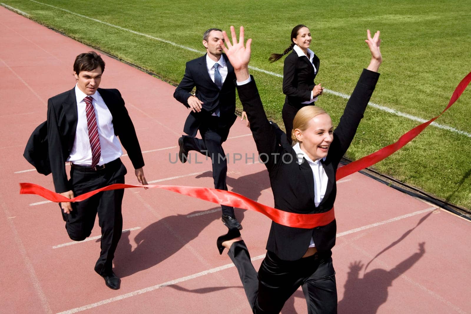 Photo of businesspeople crossing the finish line