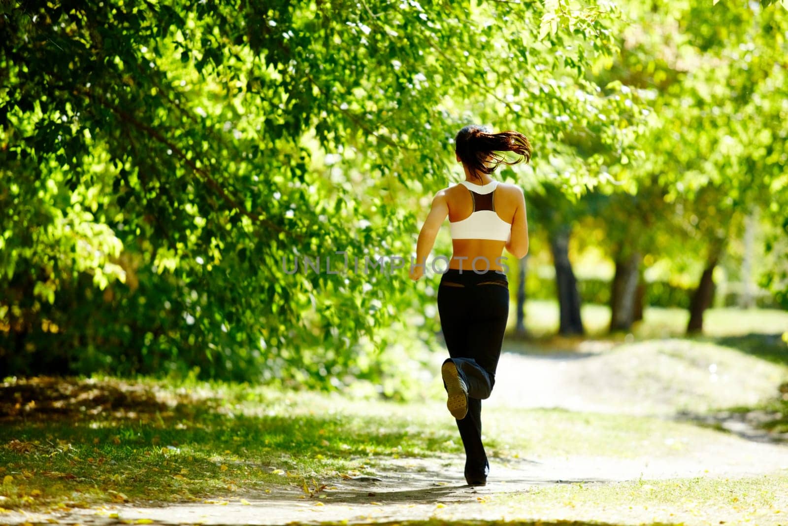 A young girl jogging in the park