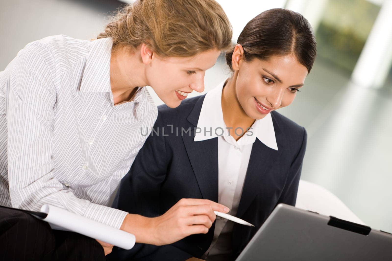 Portrait of two smiling business women working together