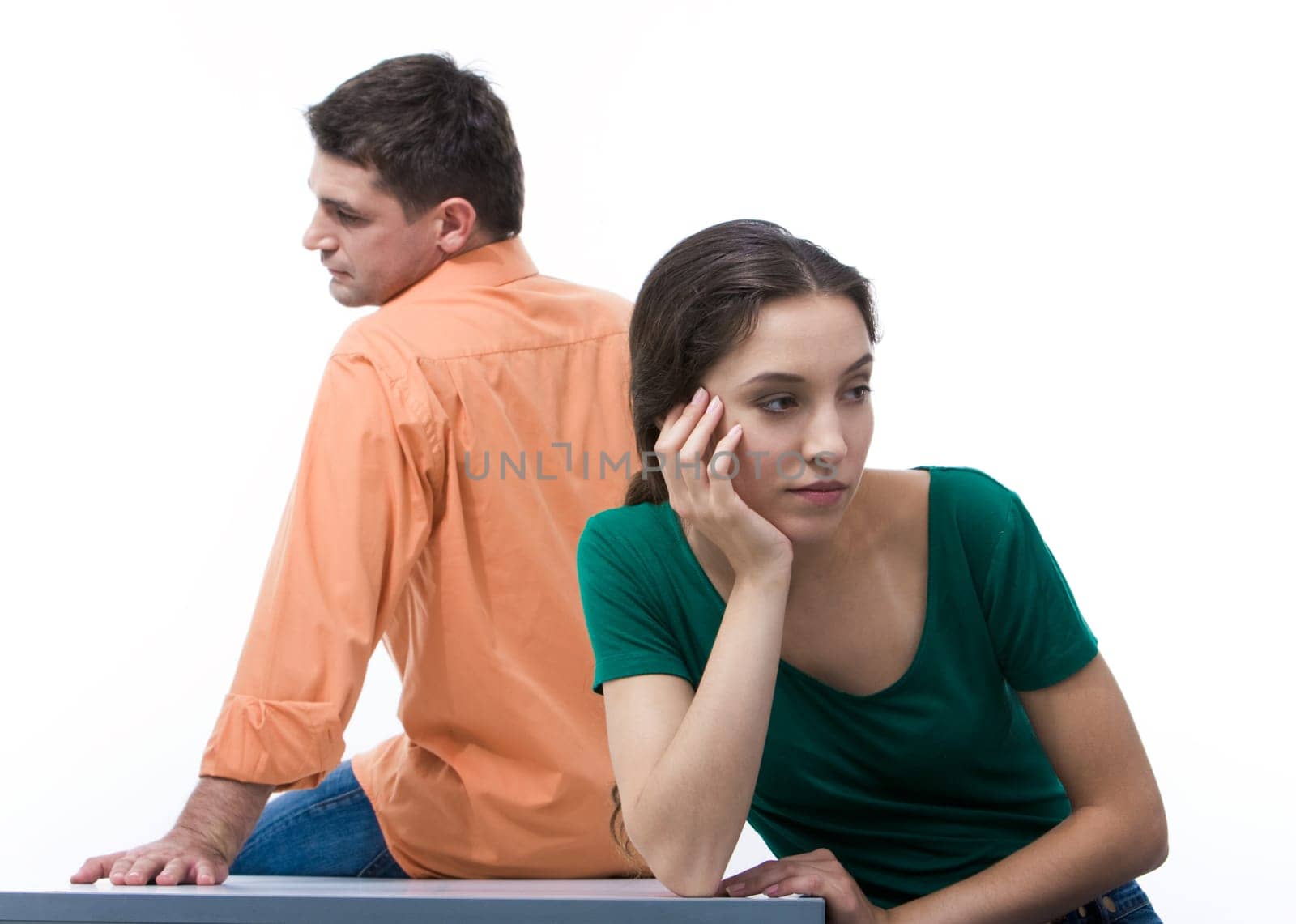 Sad woman sitting aback to boyfriend and touching her face