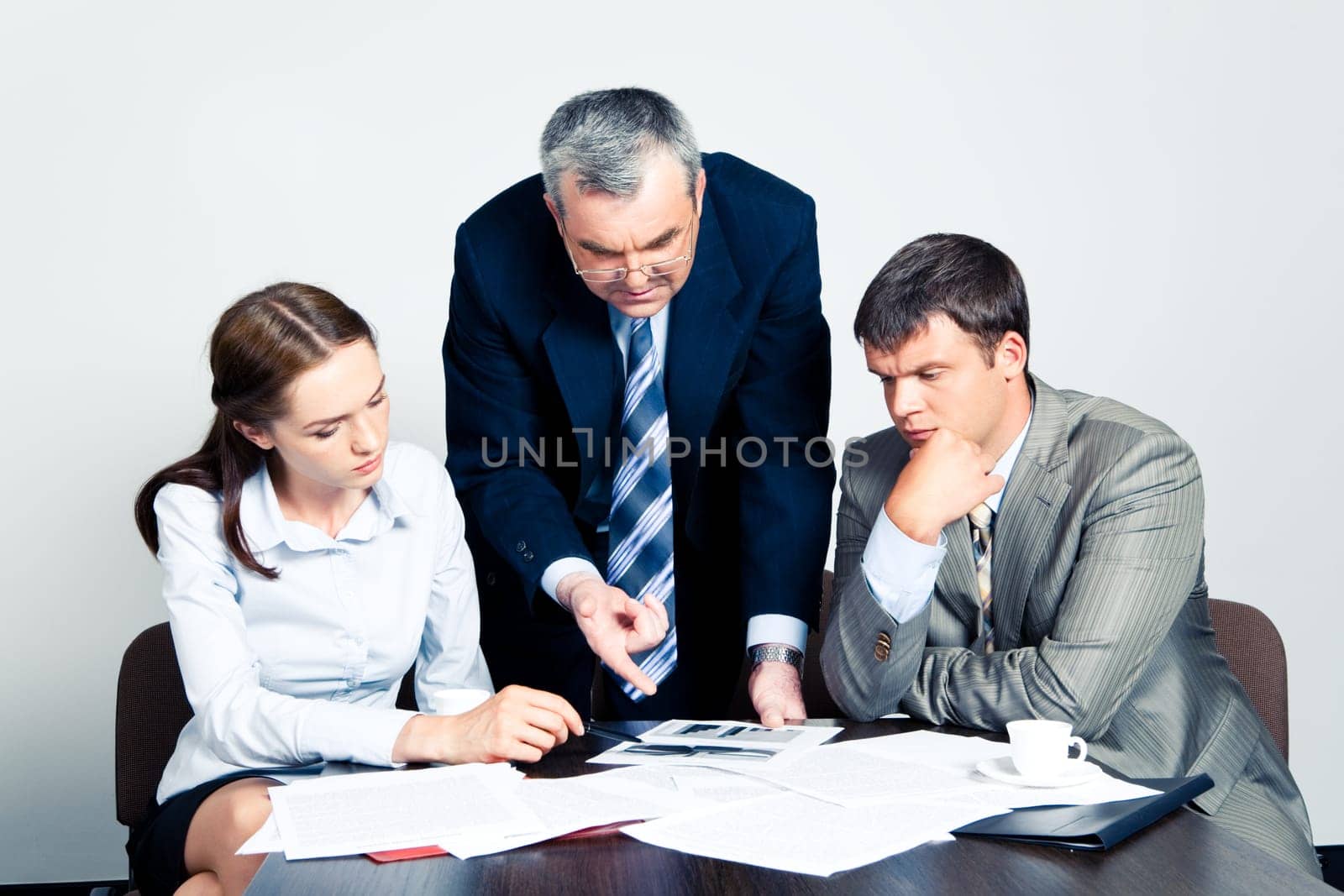 Image of confident boss giving instructions to his colleagues