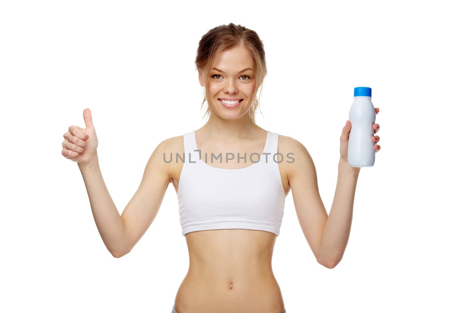 Portrait of a slim girl with a bottle of milk