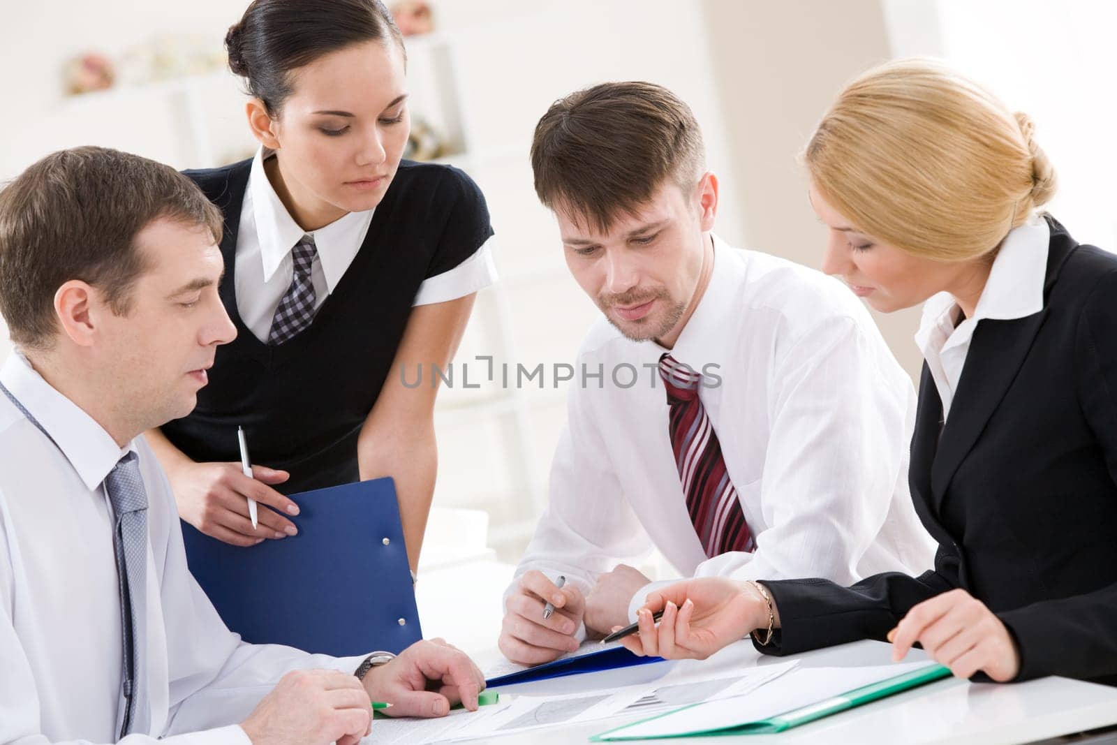 Portrait of busy people discussing new project or working plan