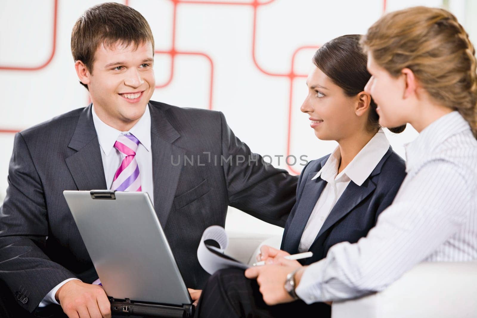 Business team of three people discussing a new project in room