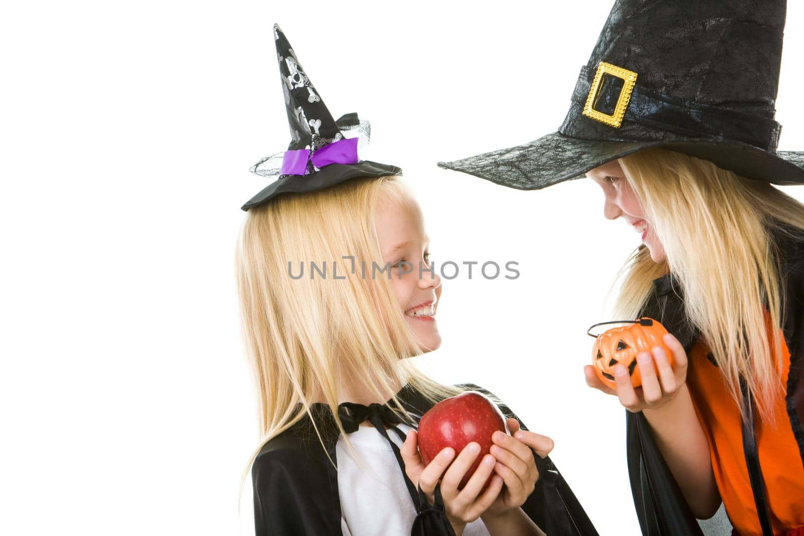 Portrait of twin girls in black hats and black clothing chatting with each other