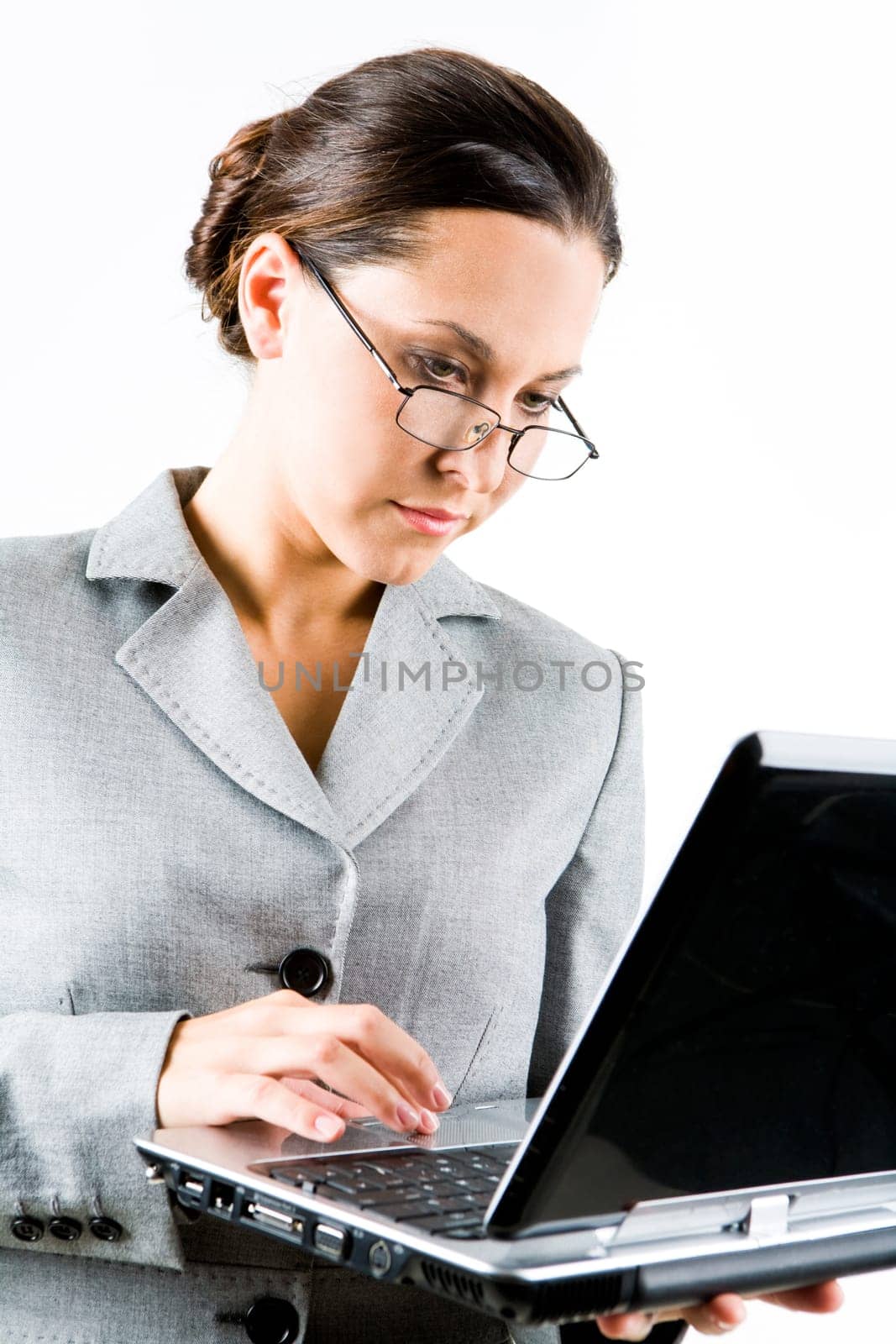 Portrait of businesswoman typing on laptop over white background