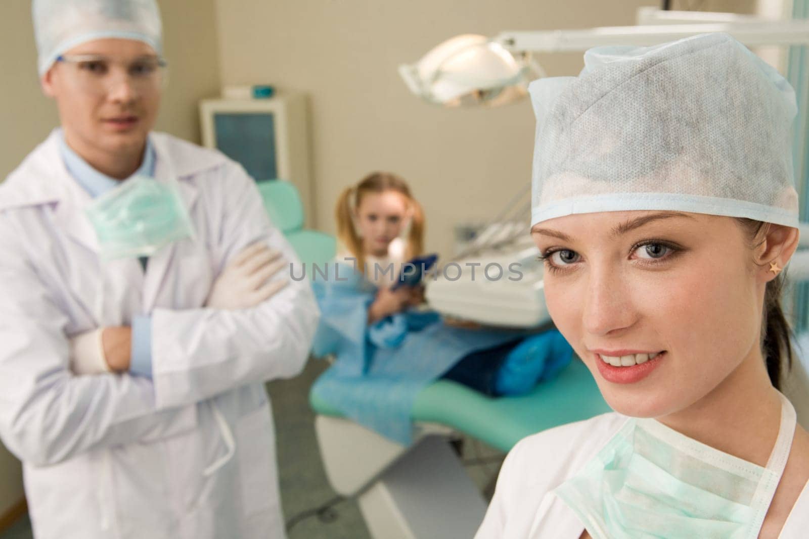 Portrait of pretty assistant looking at camera in dentistry office