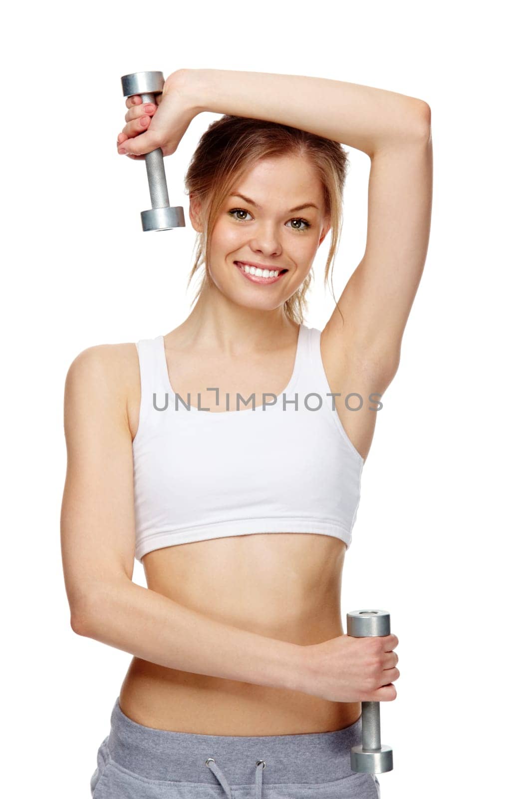 Portrait of a young cheerful girl exercising with dumbbells
