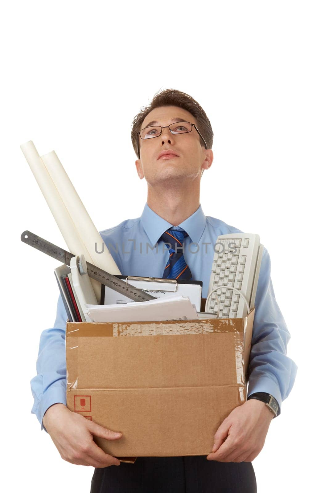 Portrait of businessman holding box with documents and looking upwards