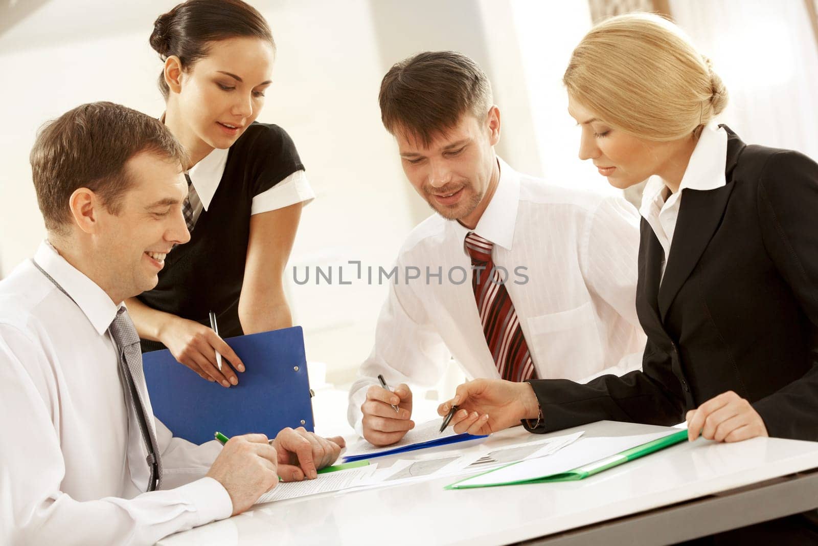Portrait of busy people discussing new project or working plan