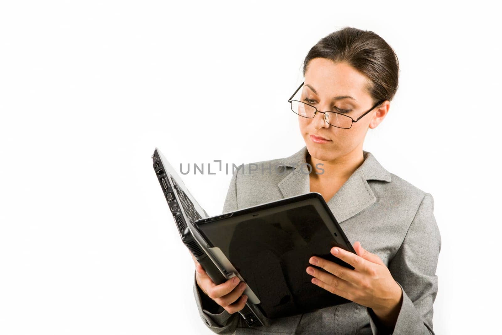 Portrait of serious businesswoman with laptop reading information from its display