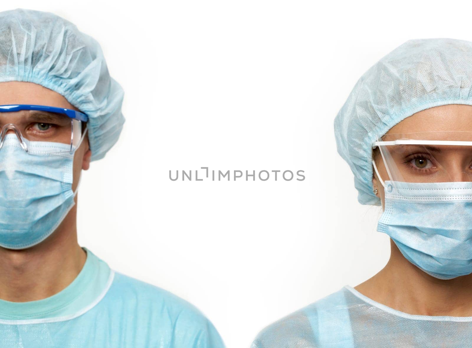 Two surgeons in masks isolated on white
