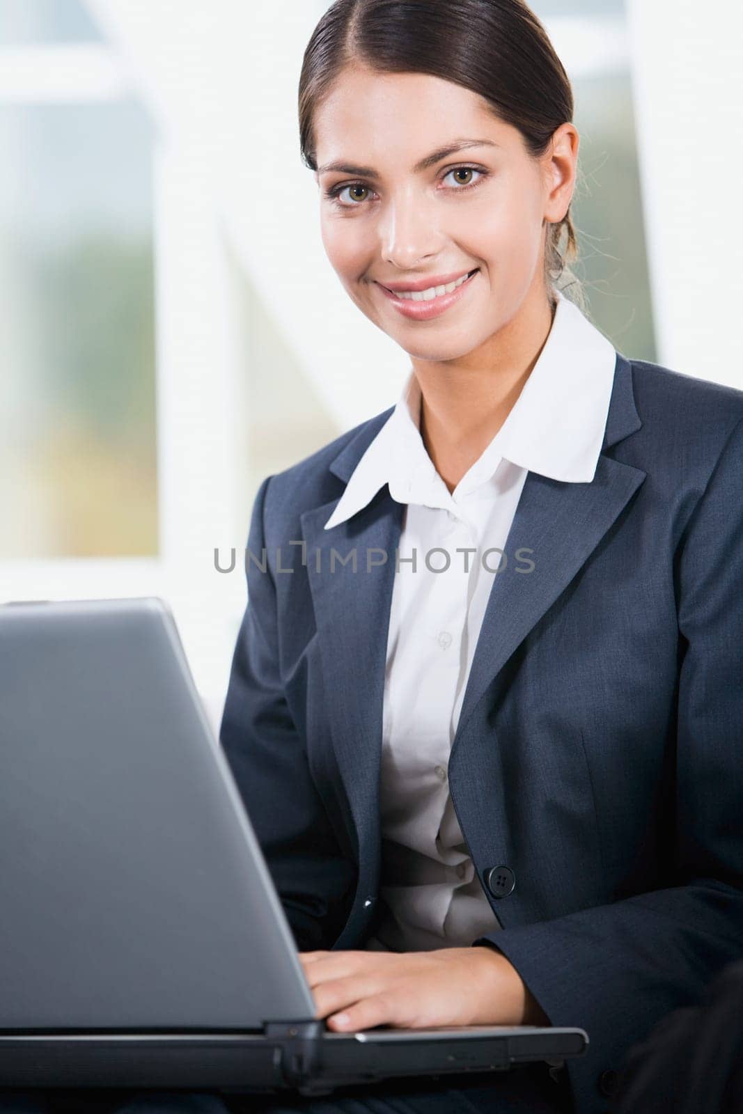 Young elegant business woman looking at camera