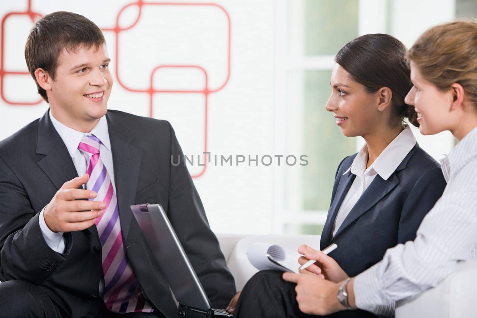Group of three young business people are discussing new plan