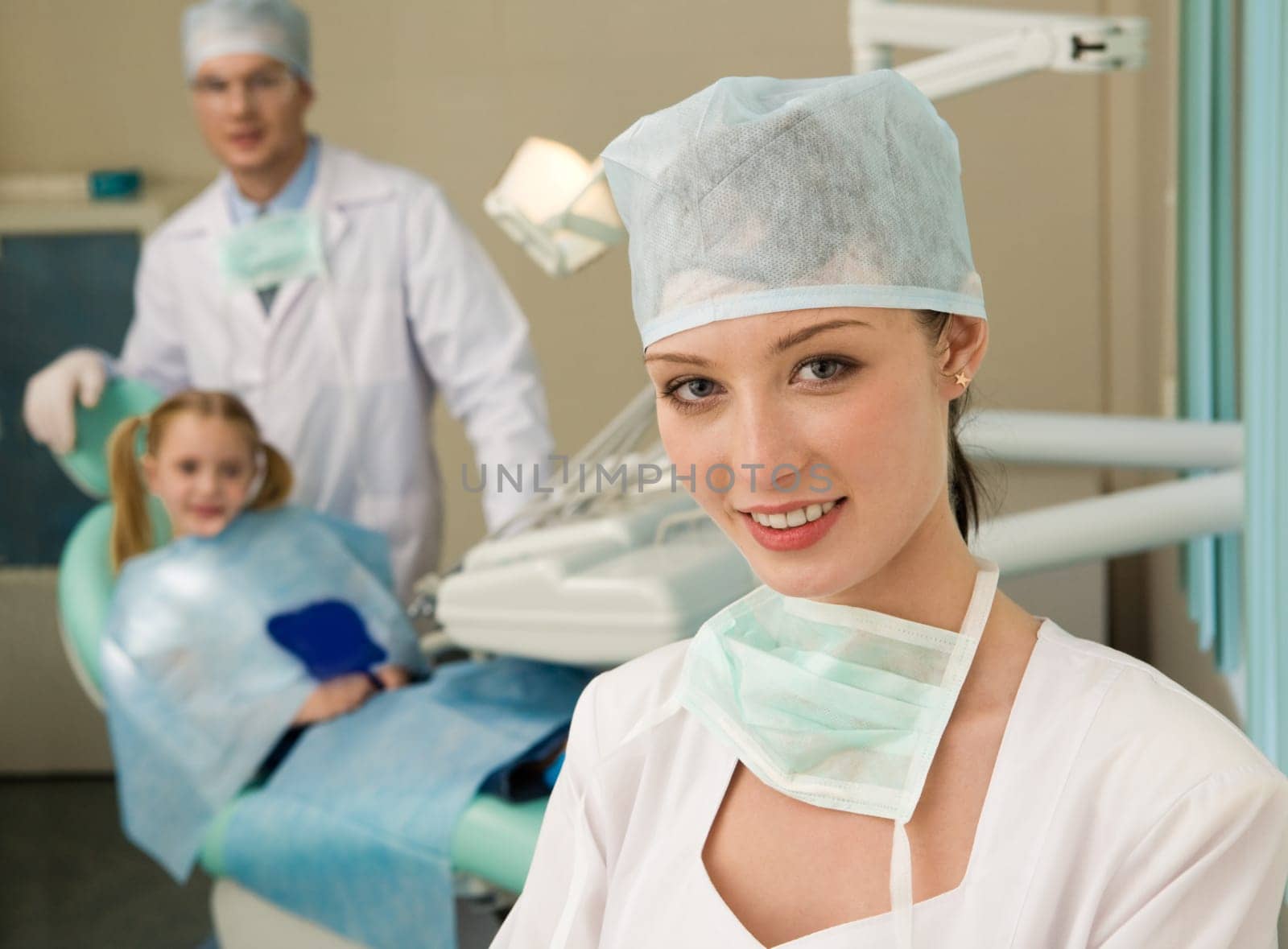 Beautiful woman wearing uniform looking at camera with smile on background of workplace
