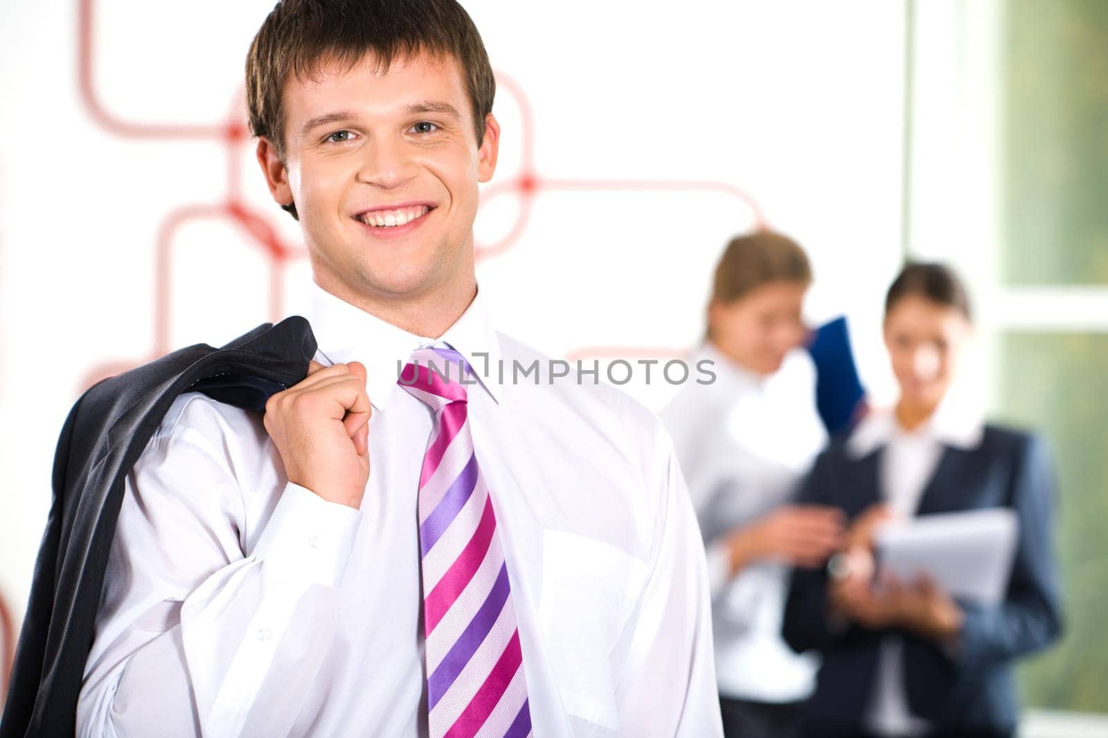 Image of business man with coat thrown through his shoulder
