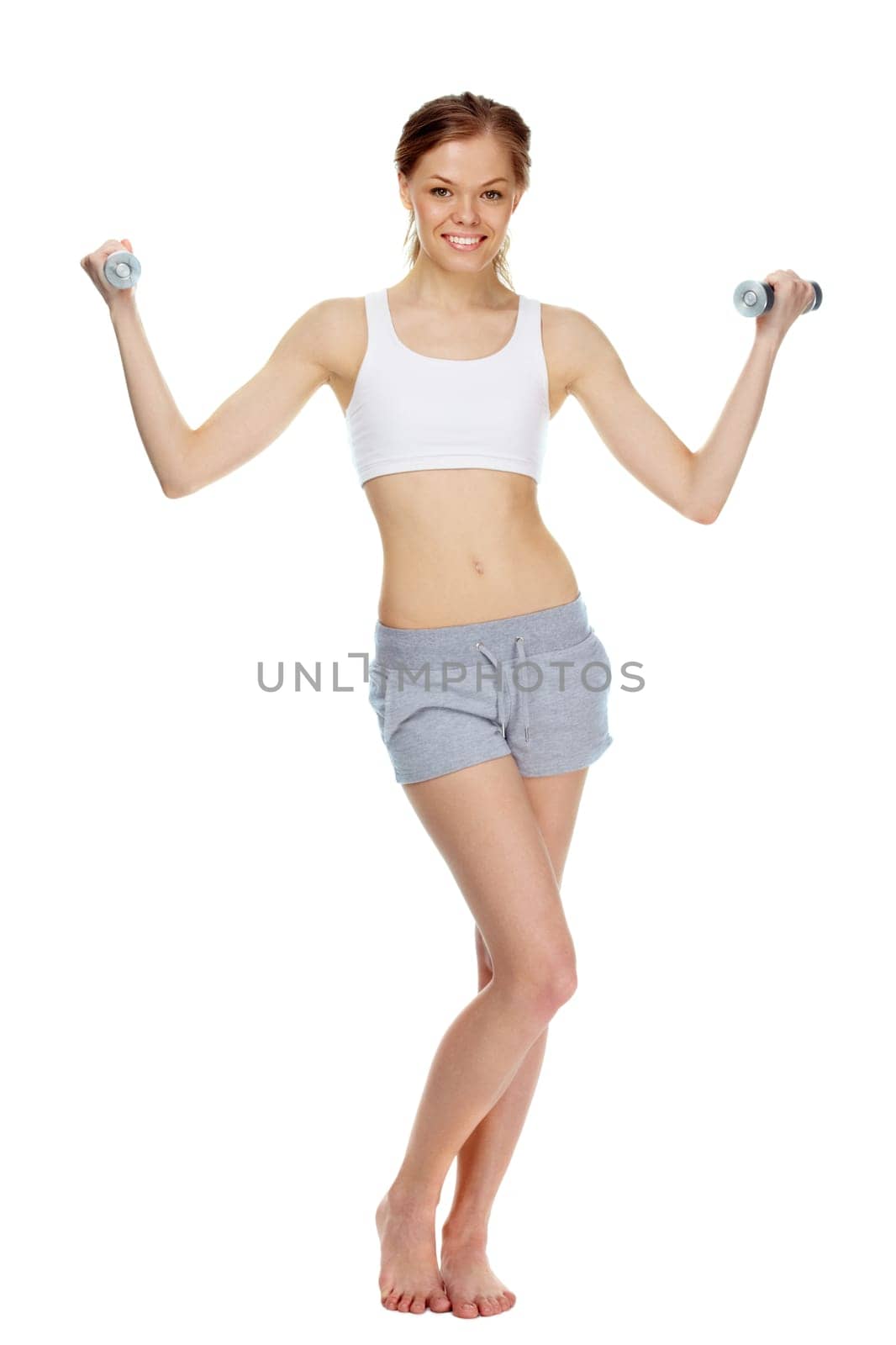 Portrait of a young girl training with dumbbells