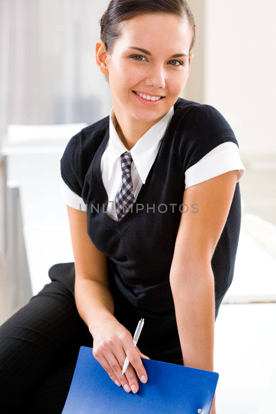 Portrait of pretty female manager looking at camera with smile