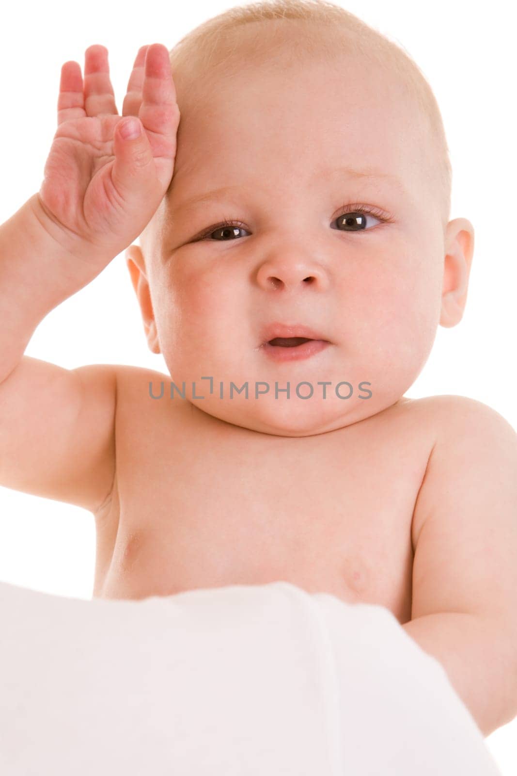 Photo of sweet baby touching forehead with funny expression