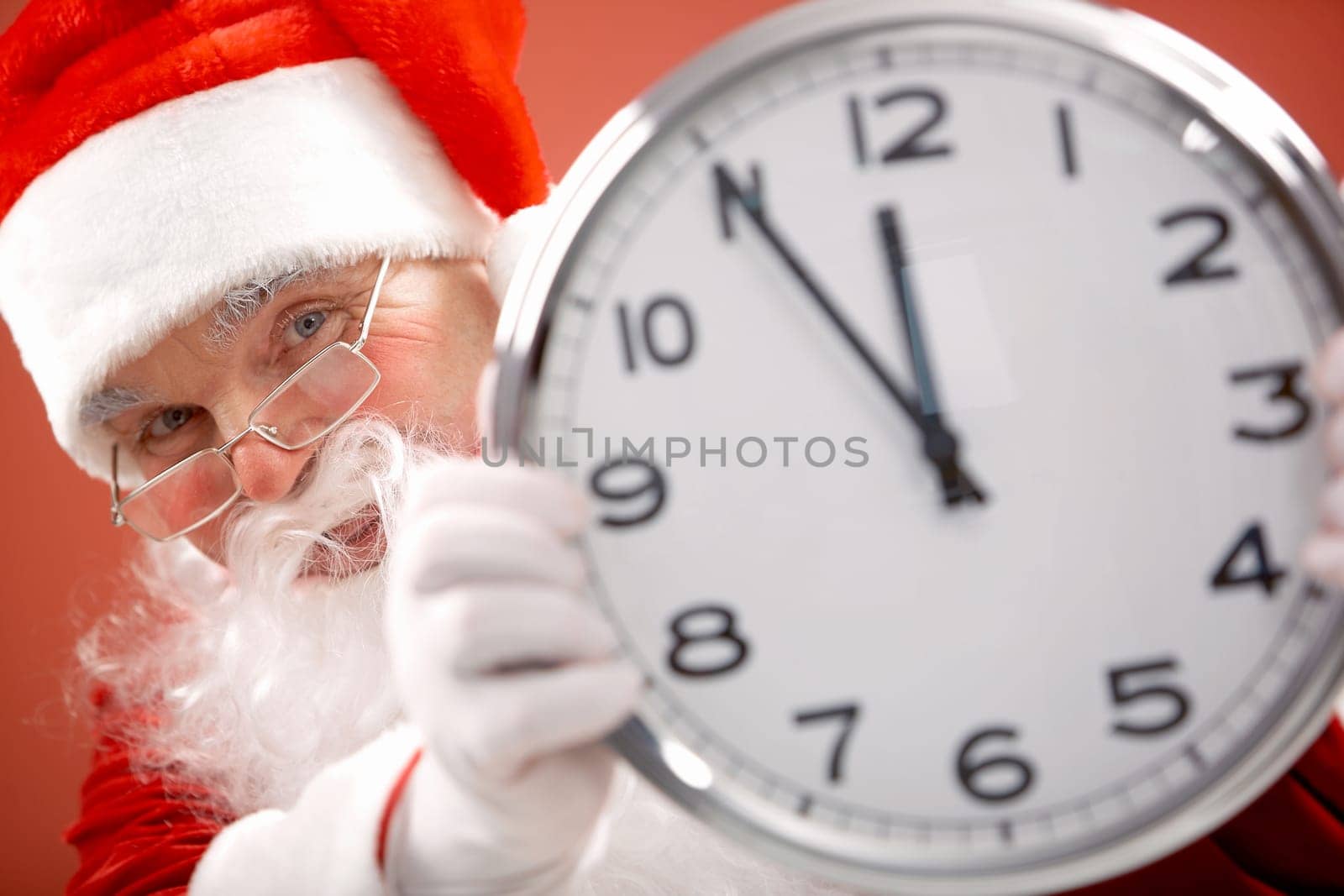 Photo of Santa holding clock showing five minutes to midnight