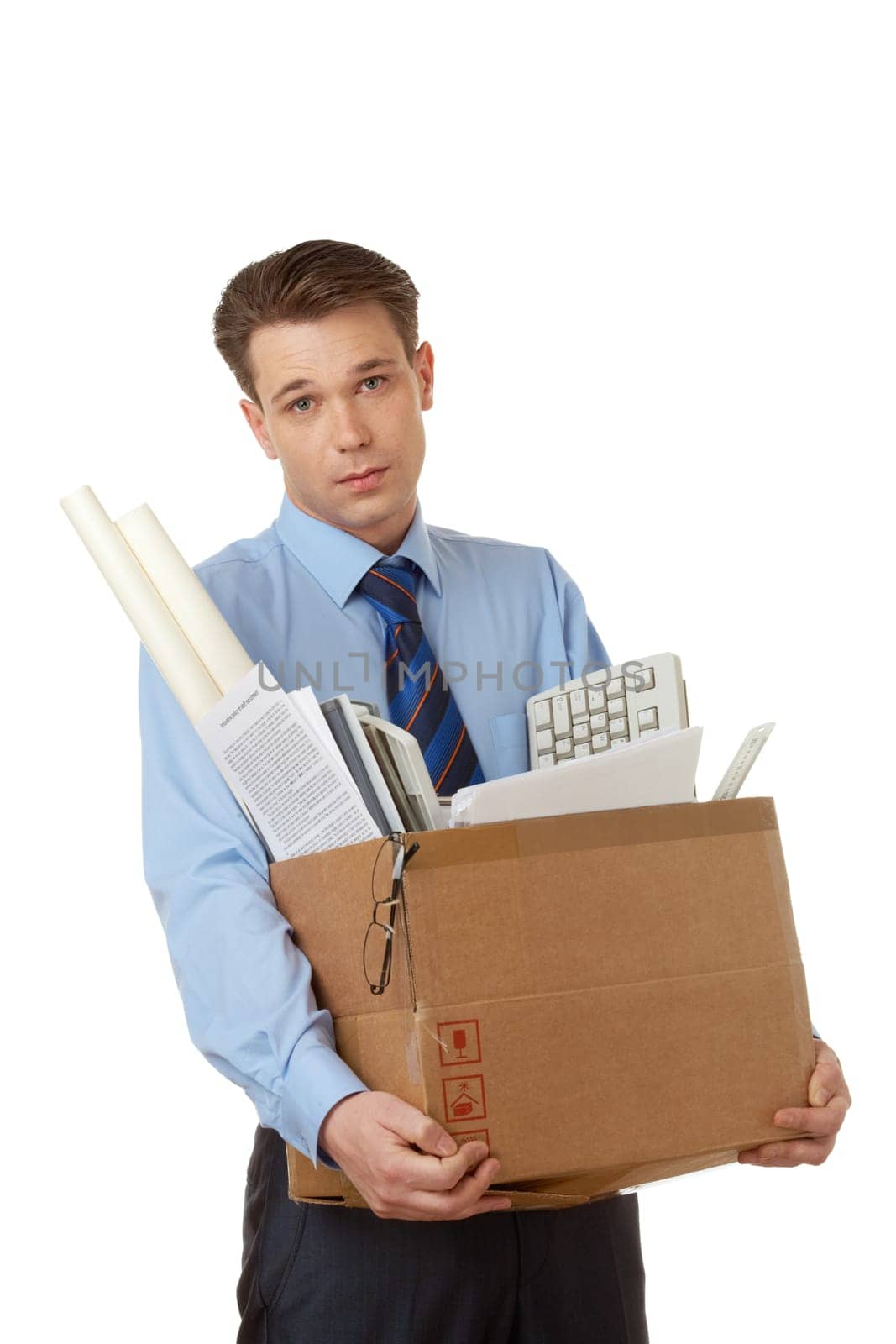 Portrait of businessman holding box with office stuff and looking at camera