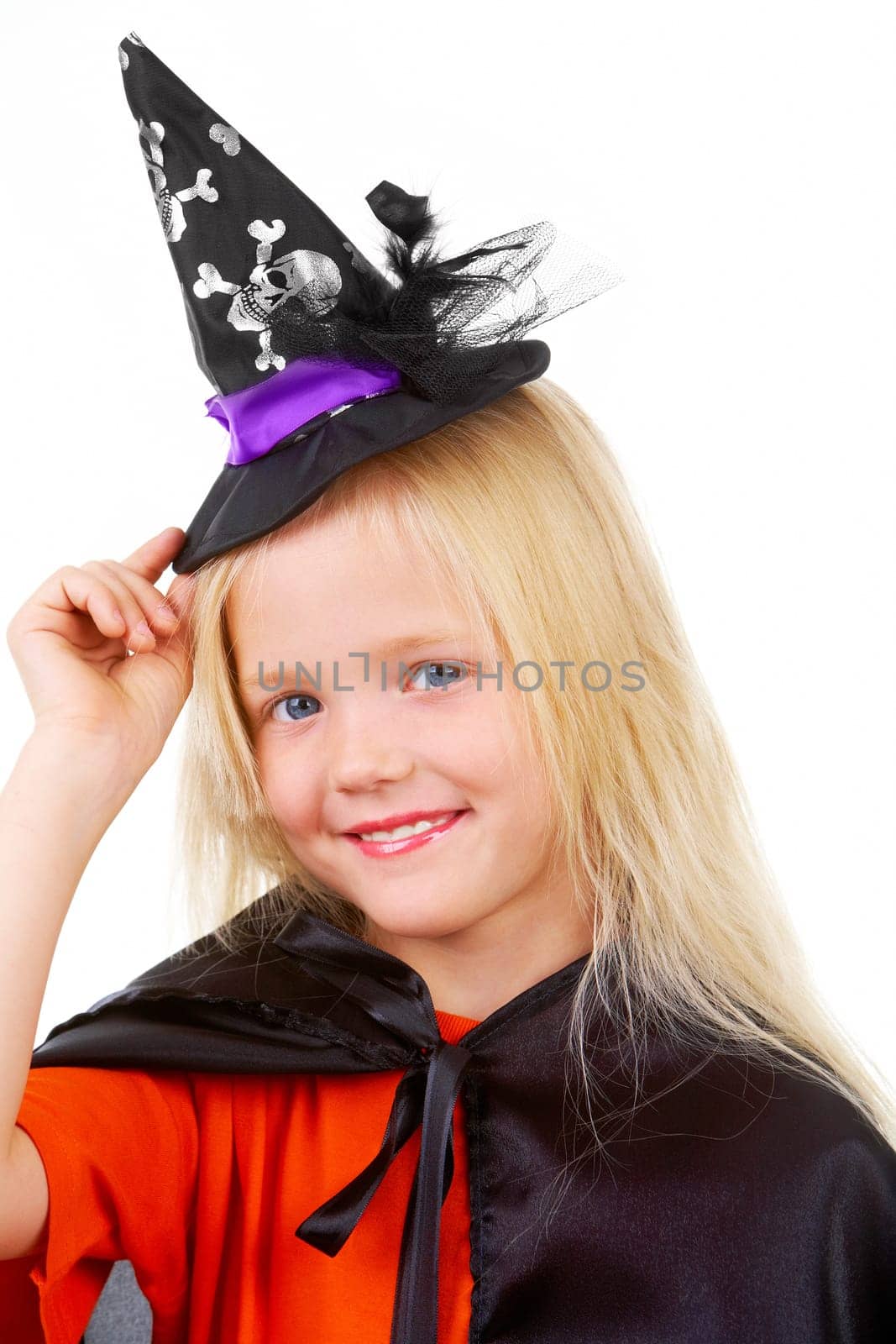 Portrait of girl in witch costume posing before camera