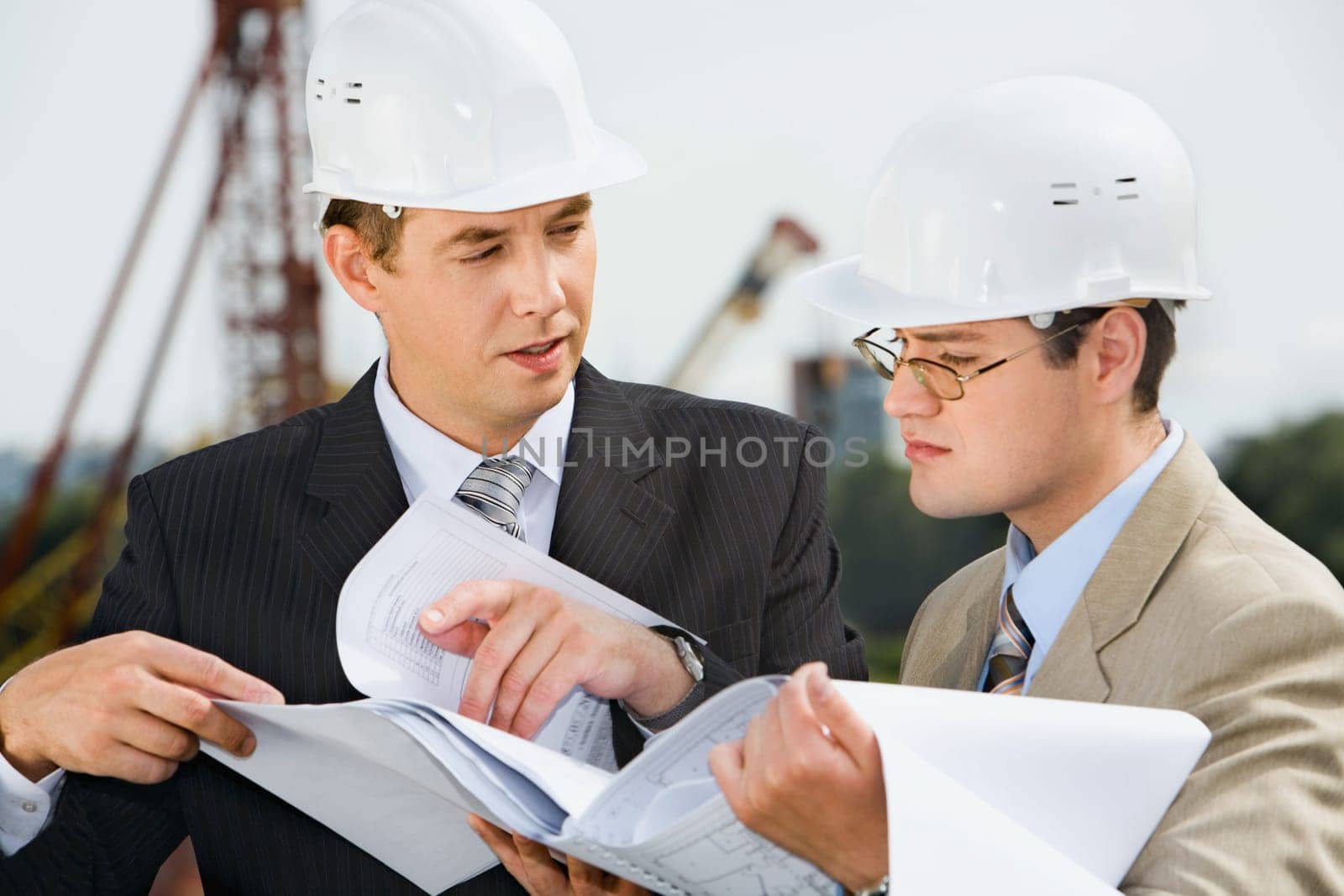 Successful architect is explaining  a conditions of project to the customer