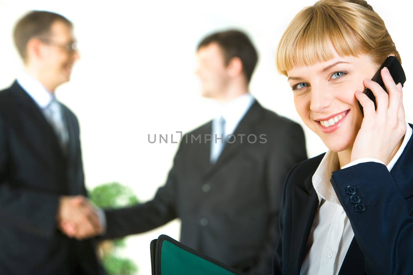 Portrait of pretty secretary speaking with her boss on phone about business bargain