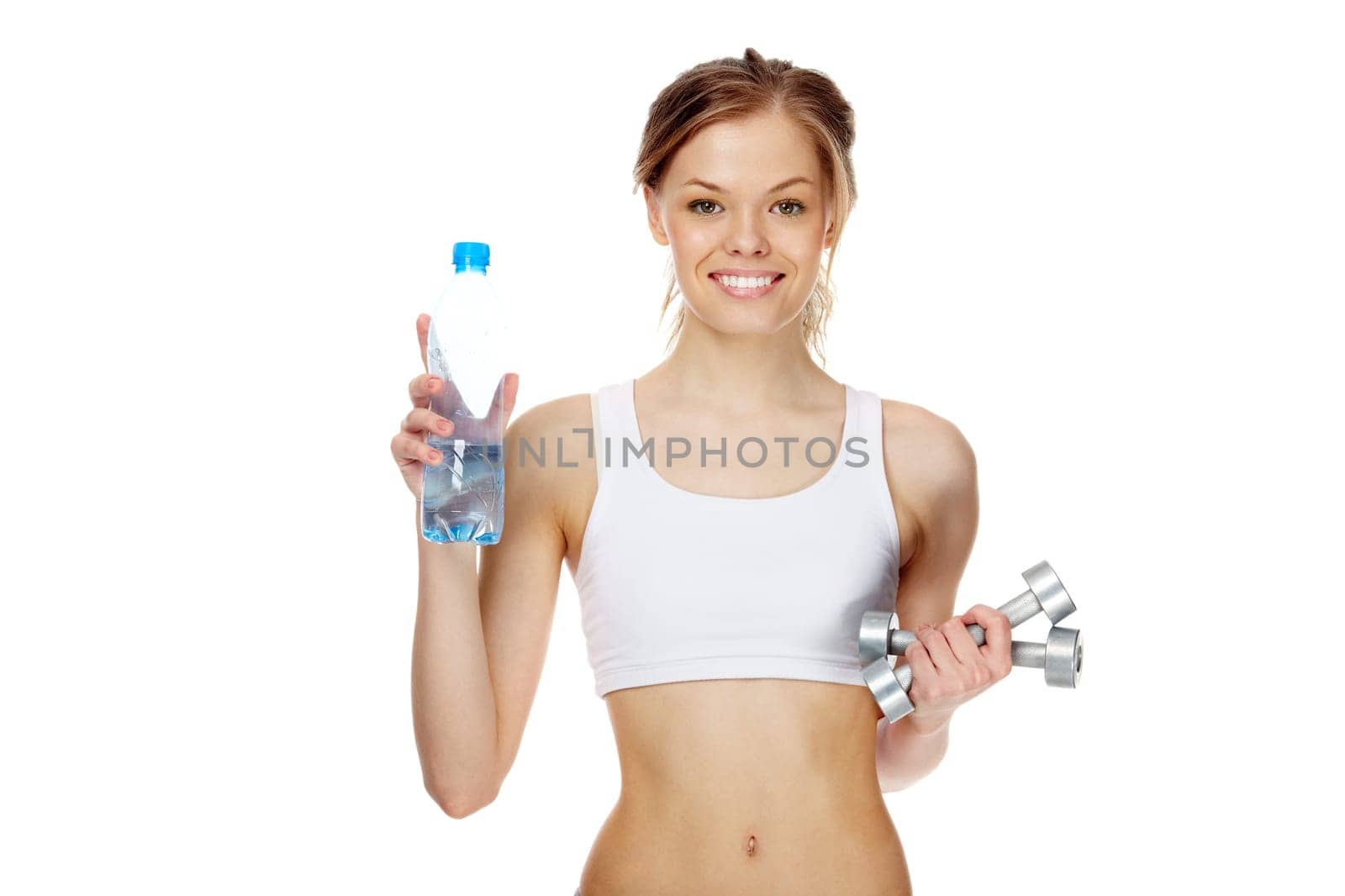 Portrait of woman with smile holding bottle of water and dumbbells