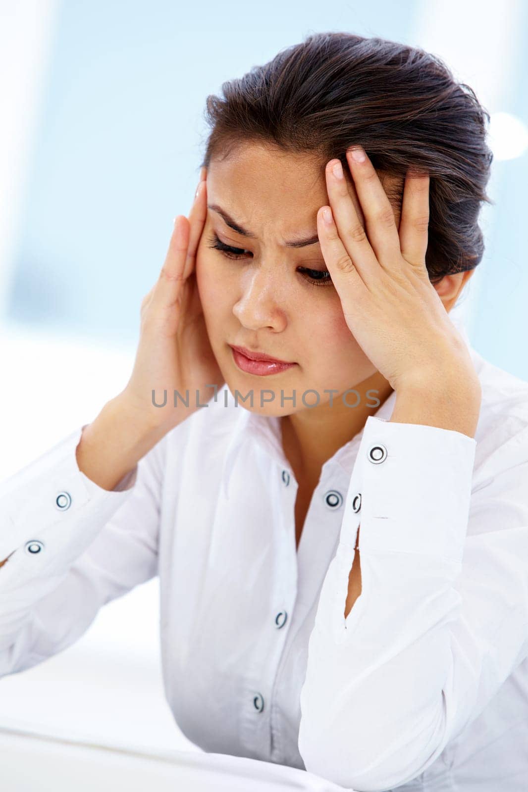 Portrait of depressed businesswoman with headache