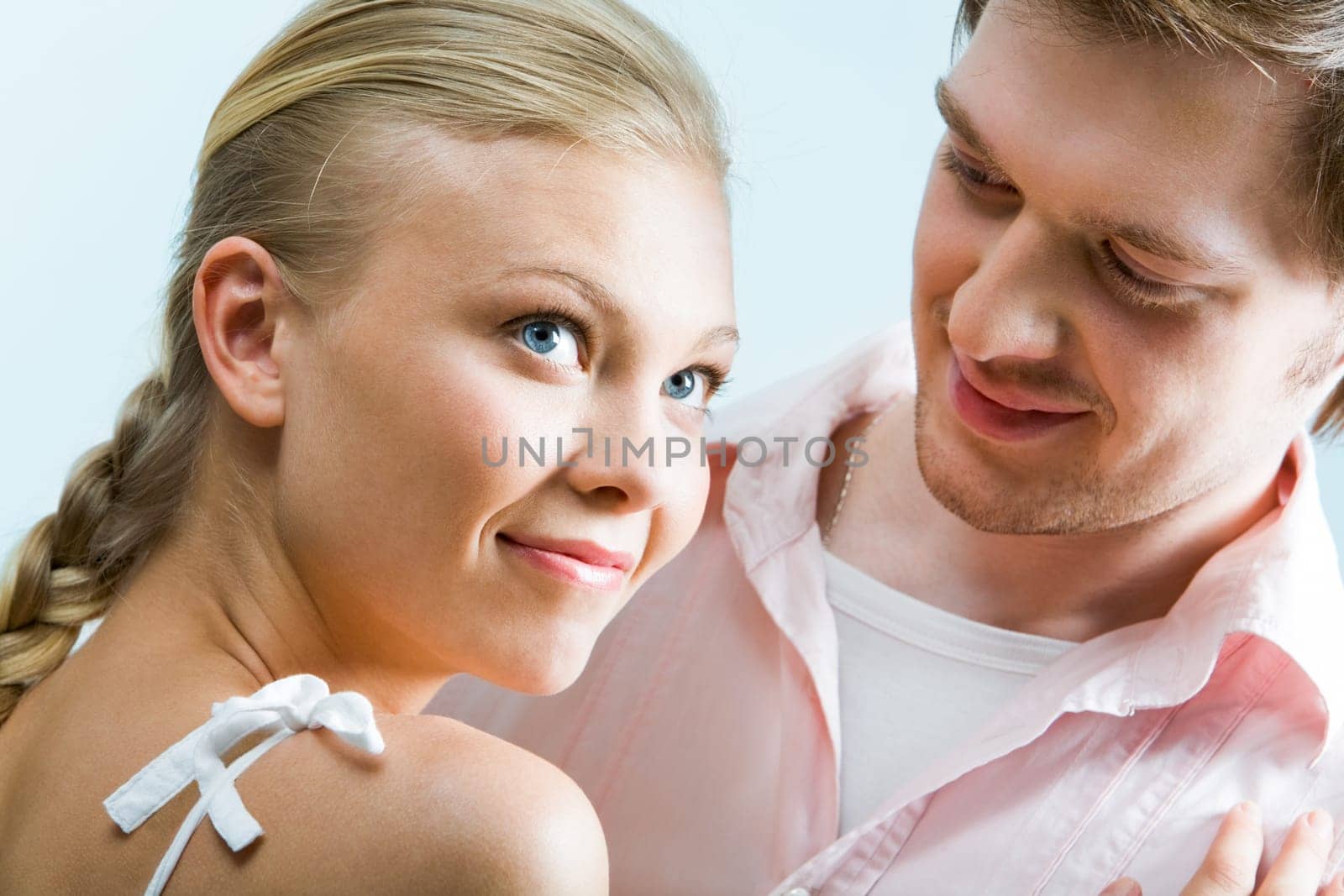 Image of cute girl staring upwards while handsome man looking at her