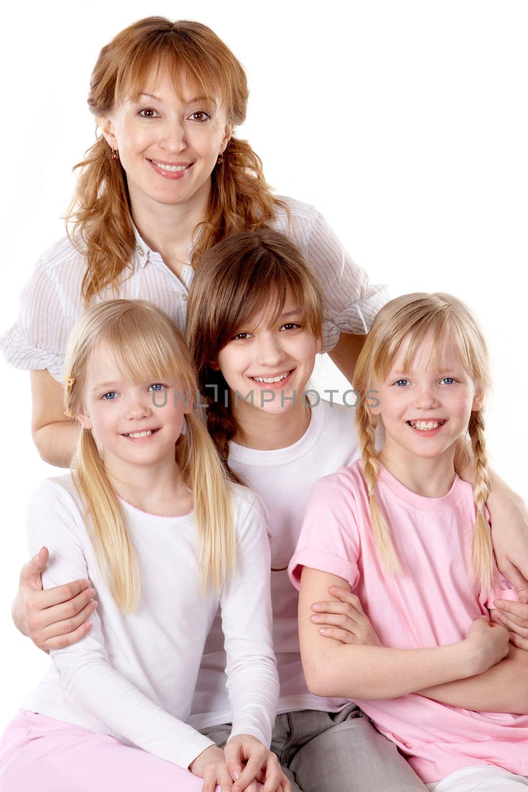 A young family of four females looking at camera