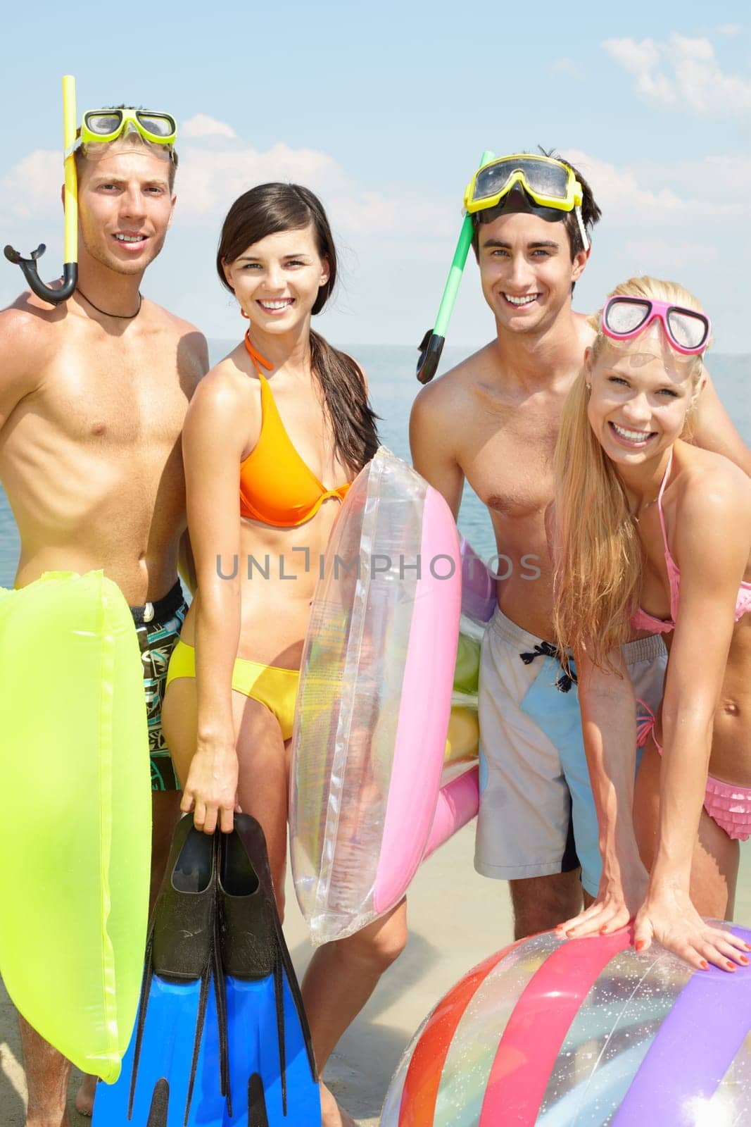 Portrait of two happy couples looking at camera and smiling on vacation