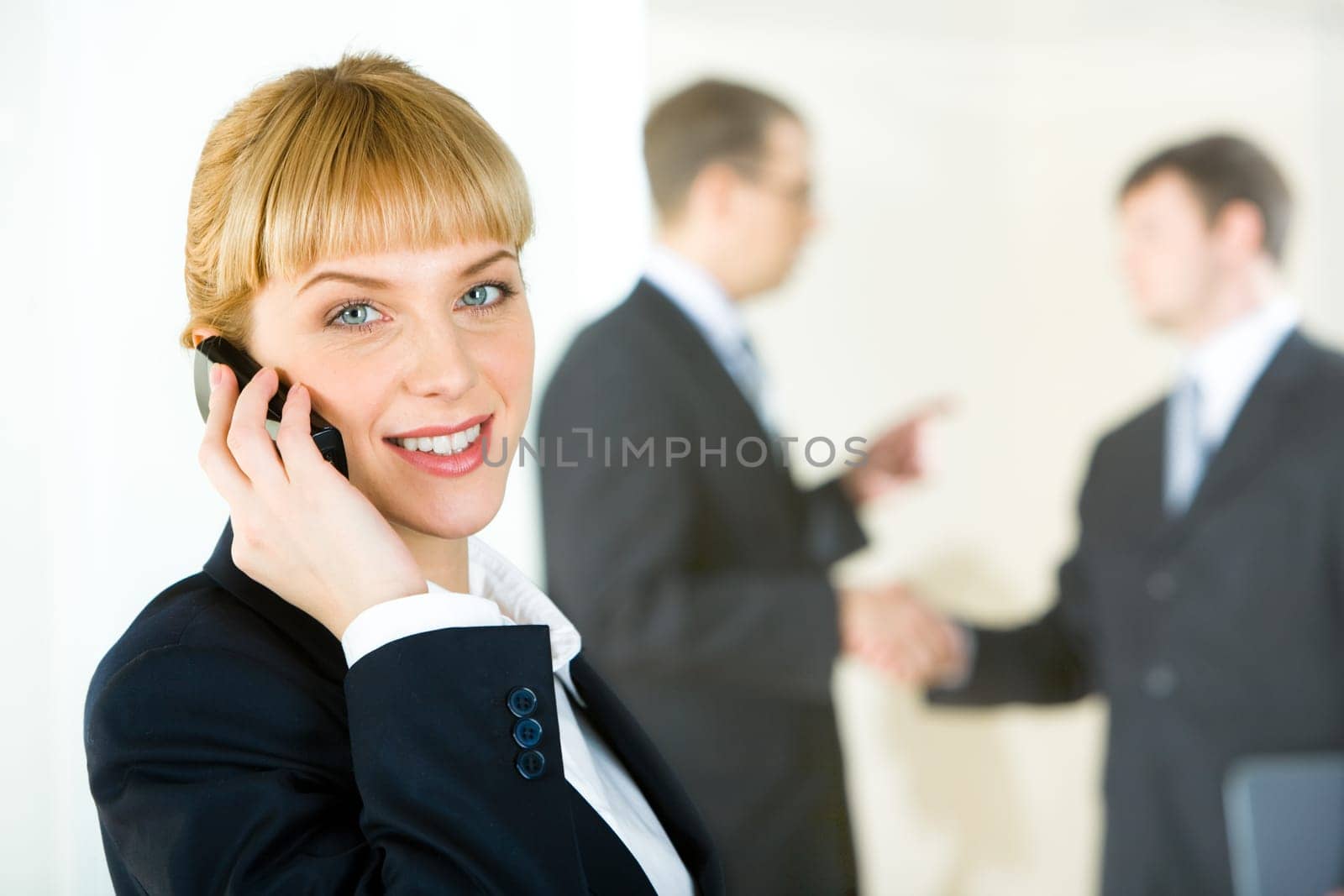 Portrait of consultant speaking on the telephone on the background of business people