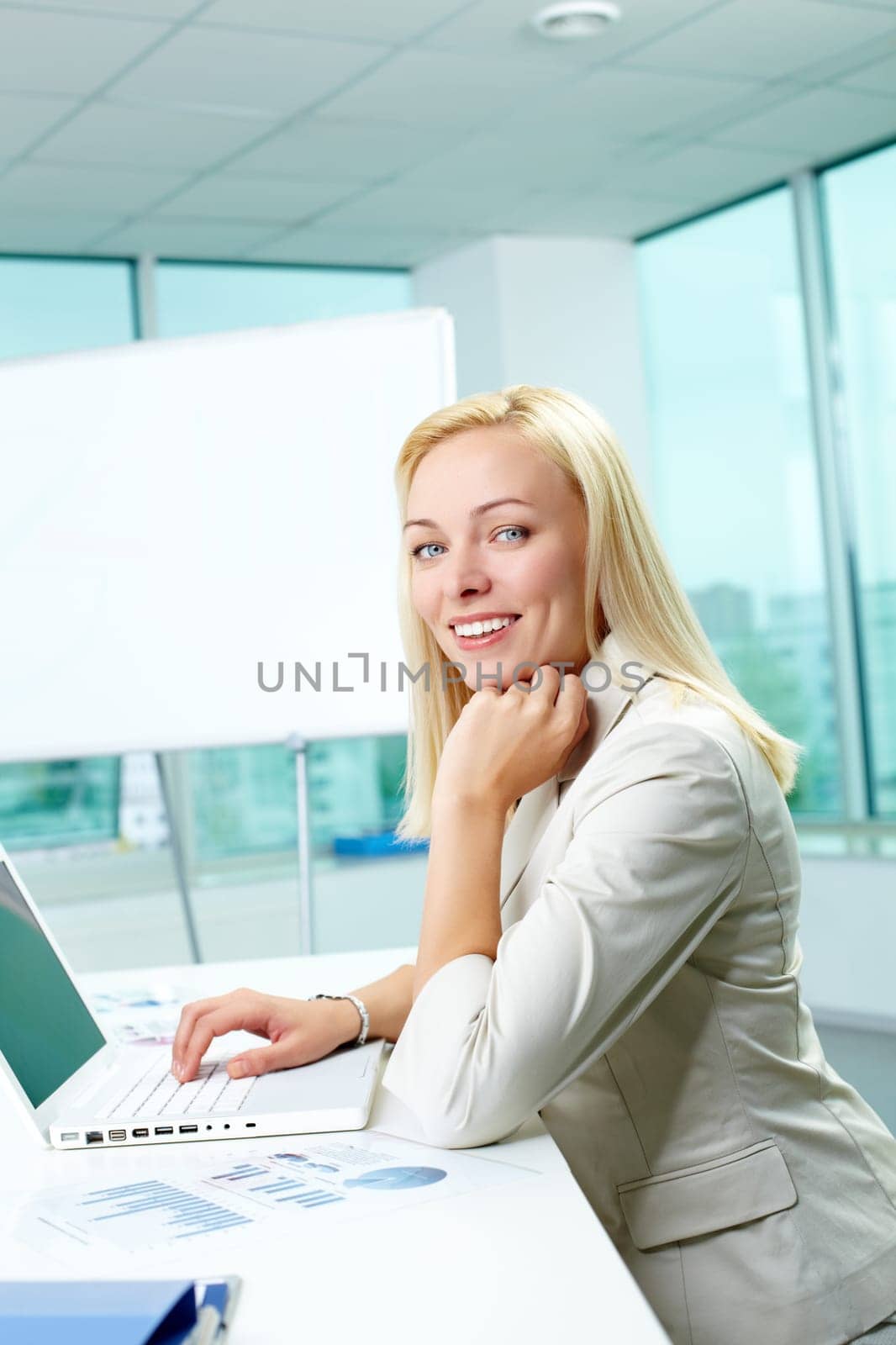 Portrait of pretty secretary looking at camera in office