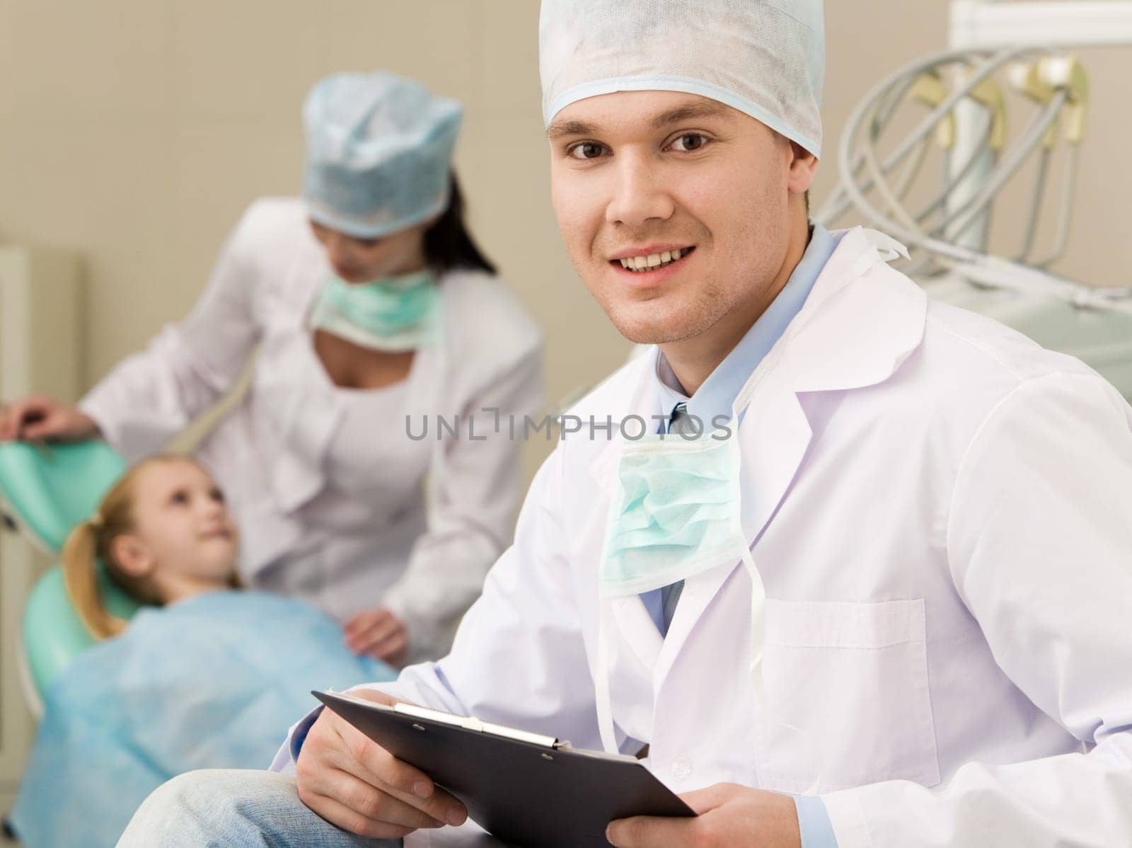 Portrait of handsome young man in uniform looking at camera with smile