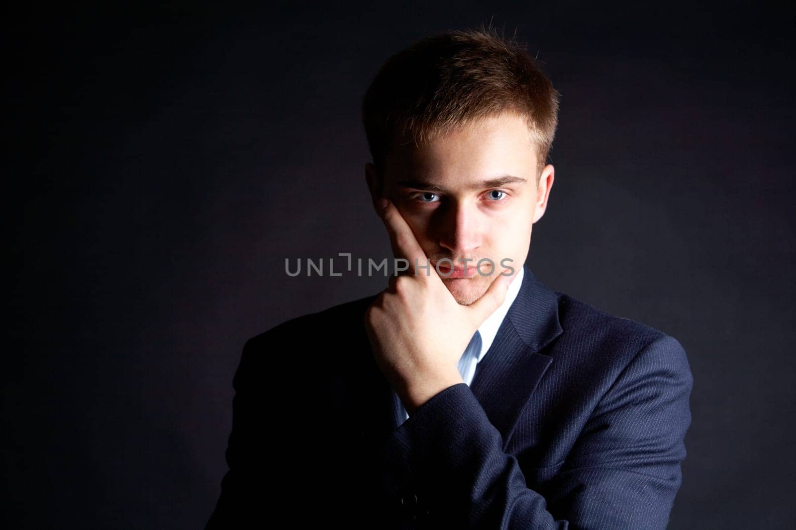 Portrait of serious businessman looking at camera